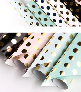 Gold foil polka dot wrapping paper detail showing various colors for gift decoration