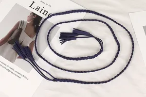 Detailed view of the vintage braided navy blue waist rope with elegant tassel ends.