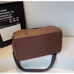 Large capacity brown travel gym bag with minimalist grid design in lifestyle setting.