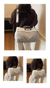 Lightweight large capacity travel duffel bag and gym bag for women shown carried on shoulder