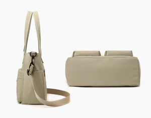 Side and bottom macro view of a khaki multi-pocket canvas commuting tote bag for women