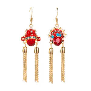 Detailed view of traditional red Peking Opera mask earrings with golden tassel chains