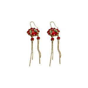 Detail shot of Chinese style retro opera mask earrings with red rhinestones and gold chains
