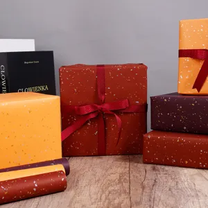 Luxury red wine colored gift wrapping paper with gold foil star pattern speckles