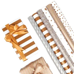 Luxuriöse geometrische Geschenkpapierrollen mit Goldfolie und verpackten Boxen