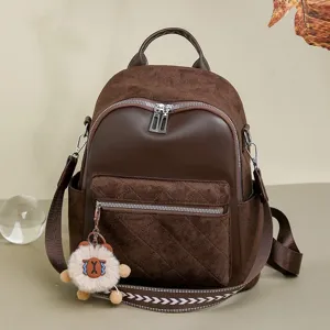 Stylish brown quilted women's backpack with decorative shoulder strap and cute charm