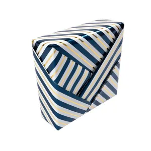 Blue and gold striped holiday gift wrapping paper with metallic finish on white background.