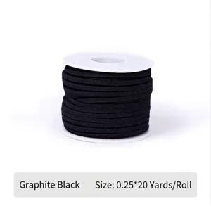 Detail of graphite black faux suede cord wound on a white spool for gift wrapping.