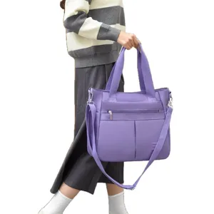 Large capacity purple nylon shoulder bag for women featuring an adjustable crossbody strap