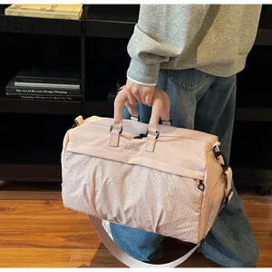 Close-up detail of a pink large capacity lightweight travel bag with a soft padded handle