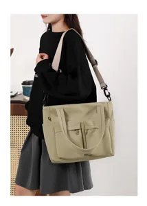 Detail view of a khaki multi-pocket commuter tote bag with adjustable shoulder strap.