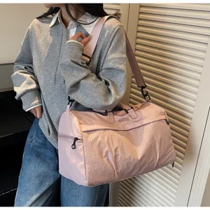 Close-up detail of a pink multifunctional gym bag with ANYOU logo and mesh texture detail