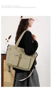 Large capacity canvas tote bag with multi-pockets worn by model for daily commute.