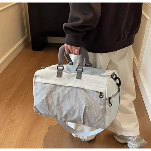 Detailed side view of a large cream and grey travel duffle bag with ANYOU embroidery