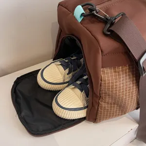 Brown multi-functional travel bag featuring a separate shoe compartment for fitness