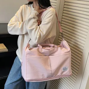 Sac de voyage pliable rose de grande capacité porté à l'épaule pour les week-ends