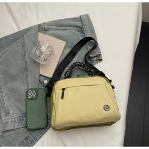 Lifestyle flat lay of a stylish lightweight yellow crossbody bag with denim jacket