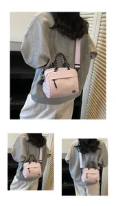 Detailed back view of a light pink minimalist crossbody bag with patterned top handles
