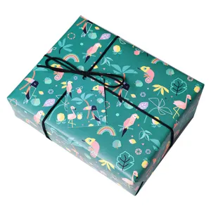 Papier cadeau à motifs d'animaux tropicaux avec étiquette assortie et ficelle noire.