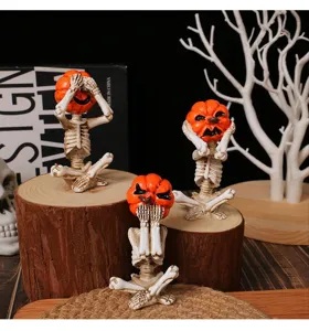 Set of three pumpkin head skeleton figurines in meditation poses for Halloween decor.