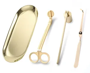 Detailed view of 4-piece gold stainless steel candle care tool set on white background
