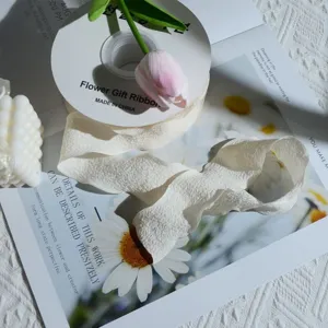 Detailed view of creamy white pleated chiffon ribbon for elegant floral and gift wrapping
