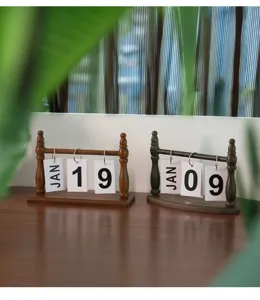 Close-up of two vintage wooden flip calendars displayed on a desk for office decor