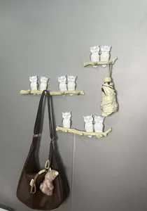 Decorative resin wall hooks featuring owls on a branch for hanging keys and coats