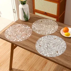 Elegant circular PVC placemats with intricate hollow floral lace patterns for dining tables