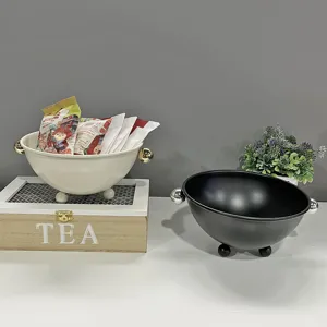 Detailansicht von cremefarbenen und schwarzen Metallschalen für Snacks