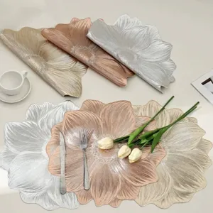 Detail view of floral PVC placemats in metallic gold and silver for elegant table settings.