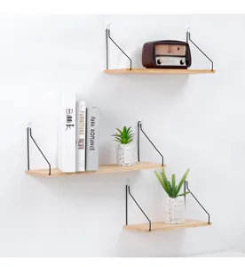 Detailed view of a modern wall-mounted wooden shelf with sturdy black metal wire brackets
