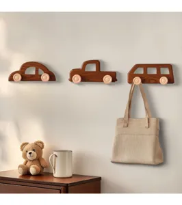 Set of three wooden car-shaped wall hooks shown in a cozy nursery room setting