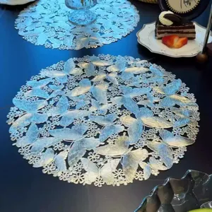 Detail shot of iridescent butterfly cutout placemat on dining table set for dessert.
