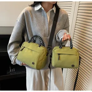 Lifestyle view of avocado green lightweight nylon crossbody bag and handbag in two sizes