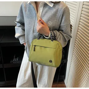 Stylish olive green lightweight nylon crossbody bag with black braided top handles