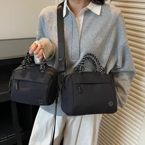 Fashionable lightweight black nylon handbag set with woven handles and adjustable strap