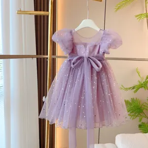 Detailed view of the purple tulle princess dress with gold stars and a large bow tie.