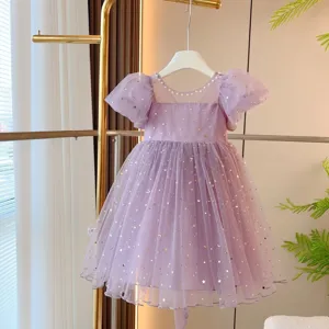Detailed view of purple girls' tulle dress with puff sleeves and gold star patterns