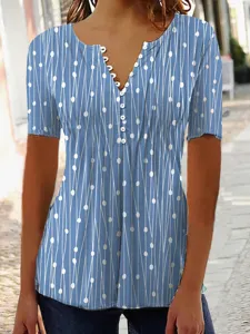 Detail view of women's blue V-neck short sleeve top with white geometric dot and line print