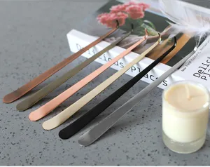 Detailed macro view of stainless steel candle wick dippers in various metallic finishes