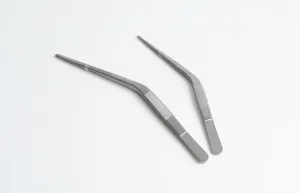 Macro detail of stainless steel knee-shaped tweezers for professional ear care.