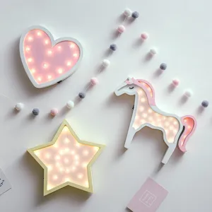 Decorative wooden LED marquee lights in heart star and unicorn shapes for nursery.