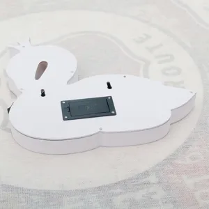 Back view of white wooden swan LED night light showing battery compartment and wall mounts