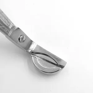 Detailed macro shot of bright chrome stainless steel semi-circular candle wick trimmer tool