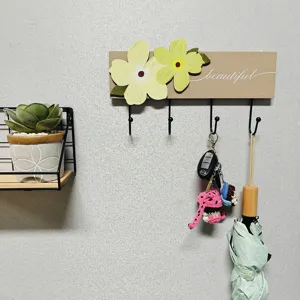 Decorative floral wooden wall hook rack with 'beautiful' text and four black metal hooks