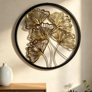 Detailansicht der modernen runden Metallwandkunst mit goldenen Ginkgoblättern im Rahmen