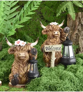Detailed macro view of two Highland cow solar garden statues with lanterns in a mossy setting.