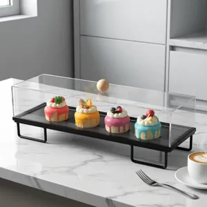 Detalle del soporte rectangular de acrílico para tartas con tapa y base de metal negro
