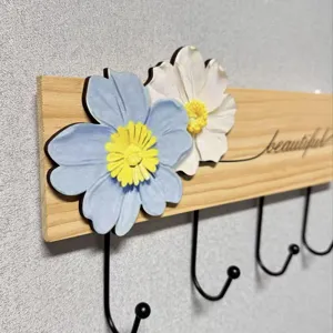 Detailed view of solid wood wall hook with 3D floral decoration and four black hooks.